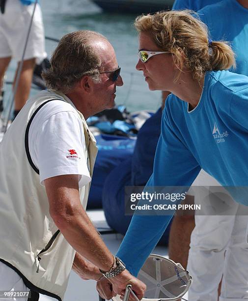 Spanish King Juan Carlos talks with his daughter Princess Cristina, 20 July 2003 in Palma de Mallorca, after winning the Breitling race after four...