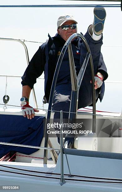 Spanish King Juan Carlos de Borbon takes the helm of the sailing ship 'Bribon' during the first race of the III Trophy Infanta Elena Sailing in...