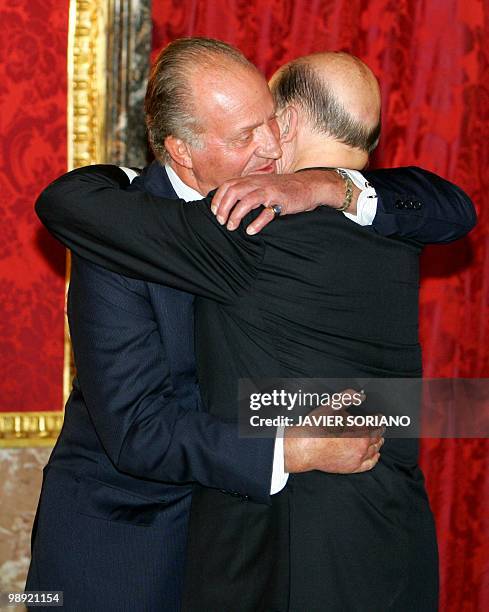 Spanish King Juan Carlos embraces Bulgarian Prime Minister Simeon Saxe-Coburg Gotha before a private dinner during Saxe-Coburg's official visit to...