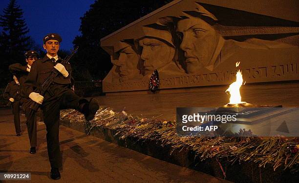 Russian cadets march near an eternal flame for those who were killed during WWII in Stavropol late on May 7, 2010. As Russia prepares to celebrate...