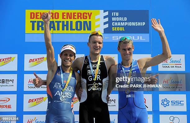 Winner Jan Frodeno of Germany is flanked by second placed Australian Courtney Atkinson and third placed Australian Brad Kahlefeldt on the podium...