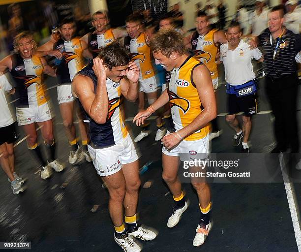 Lewis Stevenson and Brad Sheppard of the Eagles sing their team song and celebrate after winning the round seven AFL match between the West Coast...