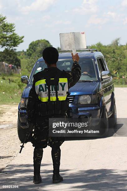 Philippine security forces inspect motorists on May 8, 2010 in Shariff Aguak, Maguindanao Province, Philippines. Shariff Aguak was the location of a...