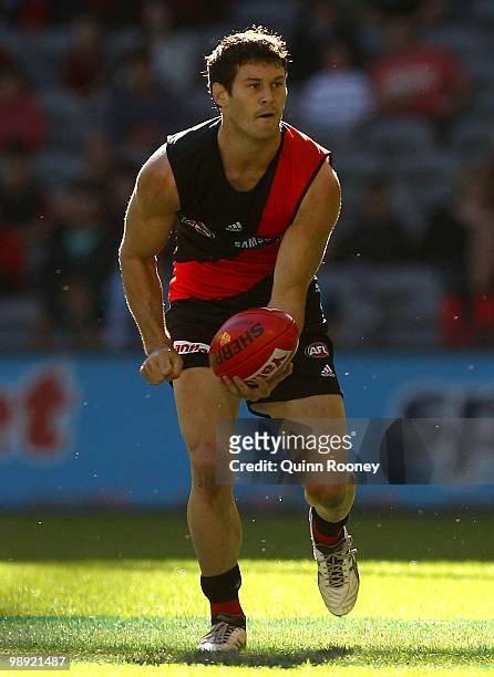 Ben Howlett of the Bombers handballs during the round seven AFL match between the Essendon Bombers and the Port Adelaide Power at Etihad Stadium on...