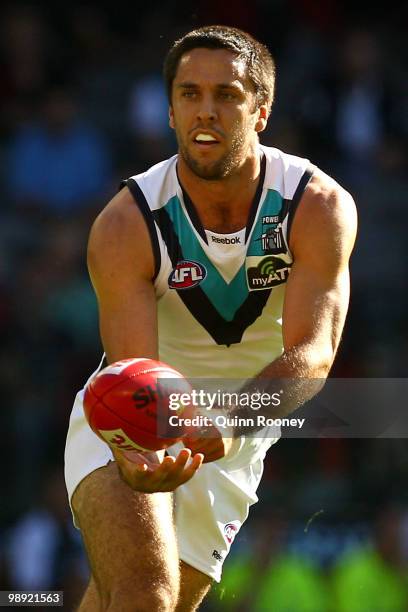 Troy Chaplin of the Power handballs during the round seven AFL match between the Essendon Bombers and the Port Adelaide Power at Etihad Stadium on...