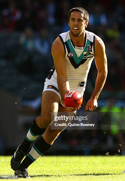 Troy Chaplin of the Power handballs during the round seven AFL match between the Essendon Bombers and the Port Adelaide Power at Etihad Stadium on...