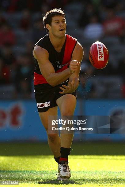 Ben Howlett of the Bombers handballs during the round seven AFL match between the Essendon Bombers and the Port Adelaide Power at Etihad Stadium on...