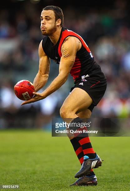 Sam Lonergan of the Bombers handballs during the round seven AFL match between the Essendon Bombers and the Port Adelaide Power at Etihad Stadium on...