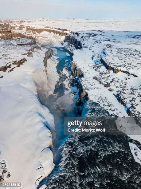 aerial view, snowy landscape, gorge, canyon with falling water masses, dettifoss waterfall in winter, northern iceland, iceland - dettifoss fotografías e imágenes de stock