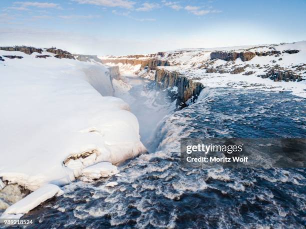 aerial view, snowy landscape, gorge, canyon with falling water masses, dettifoss waterfall in winter, northern iceland, iceland - dettifoss fotografías e imágenes de stock