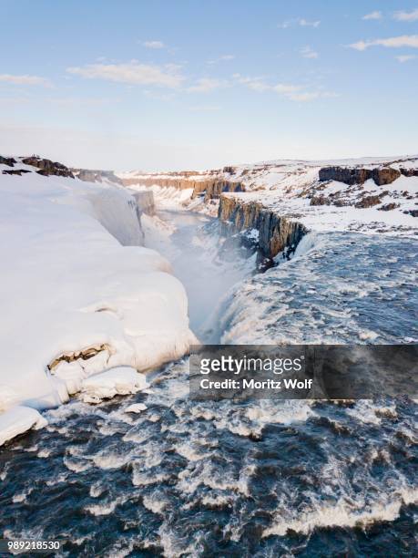 aerial view, snowy landscape, gorge, canyon with falling water masses, dettifoss waterfall in winter, northern iceland, iceland - dettifoss fotografías e imágenes de stock