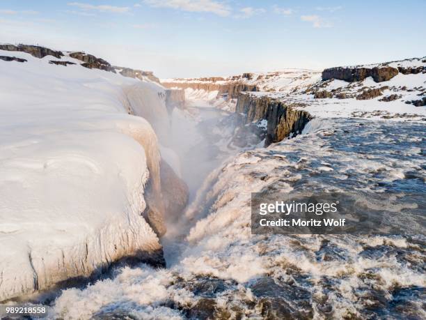 aerial view, snowy landscape, gorge, canyon with falling water masses, dettifoss waterfall in winter, northern iceland, iceland - dettifoss fotografías e imágenes de stock