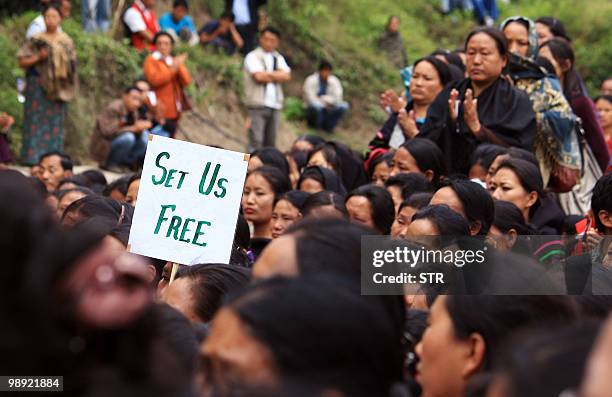 Placard reading 'Set Us Free' is held aloft as tribal Naga women hold a peace rally at the Nagaland-Manipur border, some 32 km from Kohima, capital...