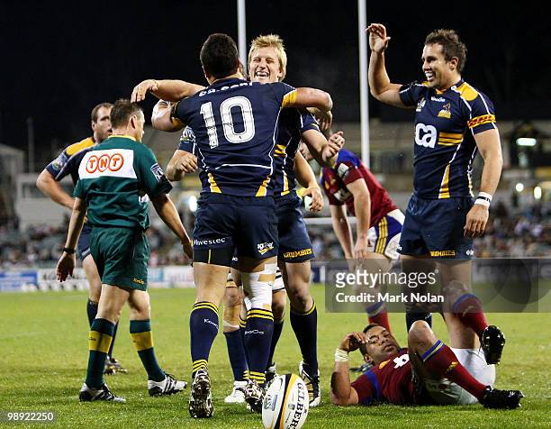 Brumbies players celebrate a try by Matt Toomua during the round 13 Super 14 match between the Brumbies and the Highlanders at Canberra Stadium on...