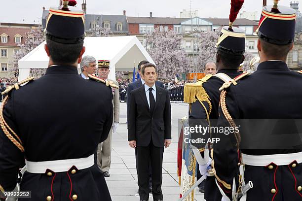France's President Nicolas Sarkozy listens to national anthem during a ceremony marking the 65th anniversary of the Allied victory over Nazi Germany...