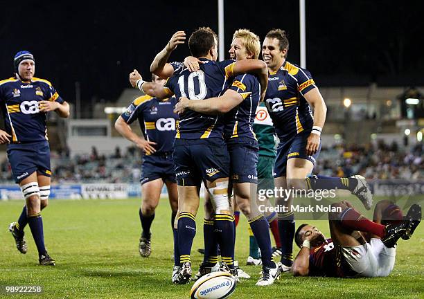 Brumbies players celebrate a try by Matt Toomua during the round 13 Super 14 match between the Brumbies and the Highlanders at Canberra Stadium on...