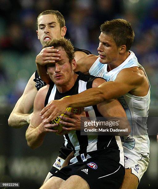 Ben Johnson of the Magpies is tackled high by Andrew Swallow of the Kangaroos during the round seven AFL match between the Collingwood Magpies and...