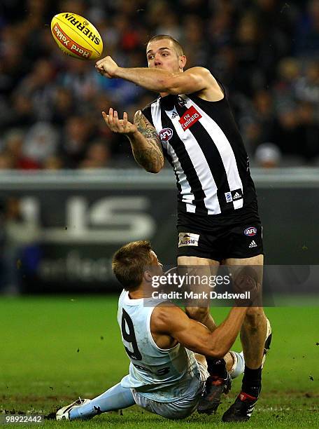 Dane Swan of the Magpies is tackled by Andrew Swallow of the Kangaroos during the round seven AFL match between the Collingwood Magpies and the North...