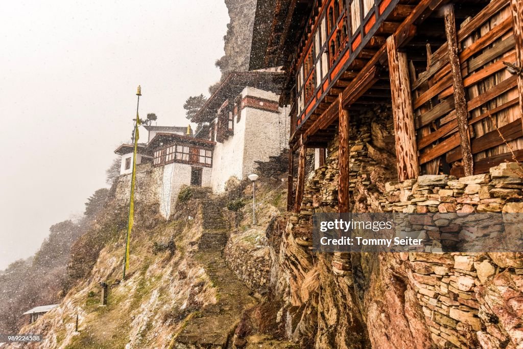Buddhist nunnery in the mountains during snowfall, Kila nunnery, between Paro and Haa, Himalayan region, Bhutan