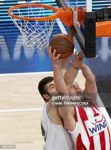 Olympiakos' Loukas Mavrokefalides scores against Partizan Belgrade's Slavko Vranes during the Final Four semifinal of Euroleague basketball match...