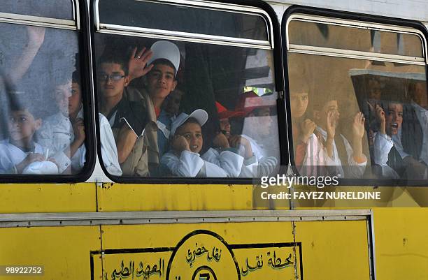 Children sit in a bus on their way to the 65th anniversary of the Setif massacre in Setif, eastern Algeria on May 8, 2010.The initial outbreak...