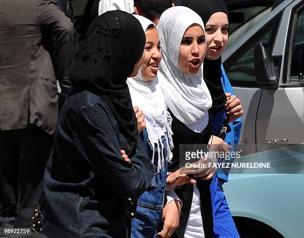Girls walk during the 65th anniversary of the Setif massacre in Setif, eastern Algeria on May 8, 2010.The initial outbreak occurred on the morning of...