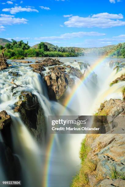 rainbow over waterfall, epupa falls, kunene region, kaokoveld, namibia - rainbow waterfall stock pictures, royalty-free photos & images