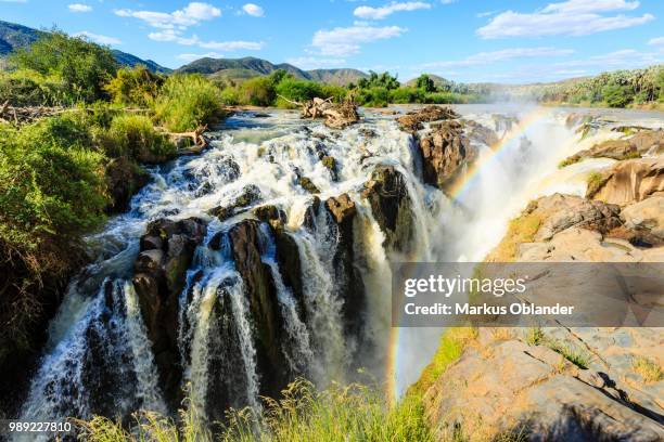 rainbow over waterfall, epupa falls, kunene region, kaokoveld, namibia - rainbow waterfall stock pictures, royalty-free photos & images