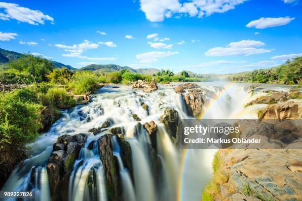 rainbow over waterfall, epupa falls, kunene region, kaokoveld, namibia - rainbow waterfall stock pictures, royalty-free photos & images