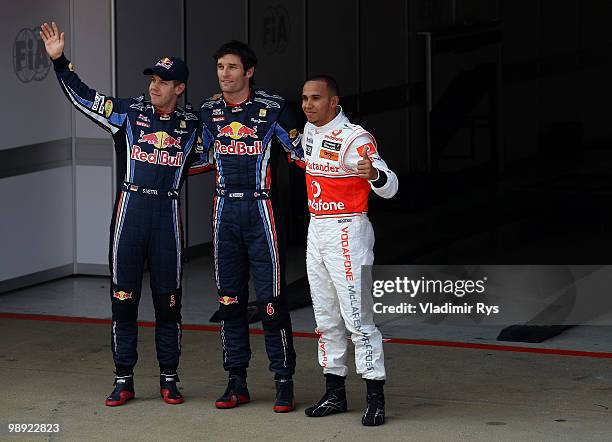 Second placed Sebastian Vettel of Germany and Red Bull Racing, first placed pole position sitter Mark Webber of Australia and Red Bull Racing and...