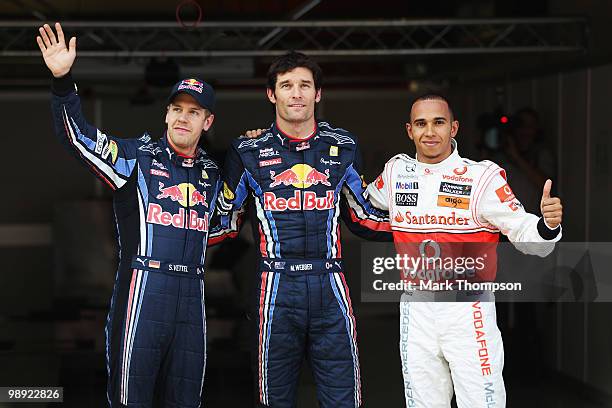 Second placed Sebastian Vettel of Germany and Red Bull Racing, first placed pole position sitter Mark Webber of Australia and Red Bull Racing and...