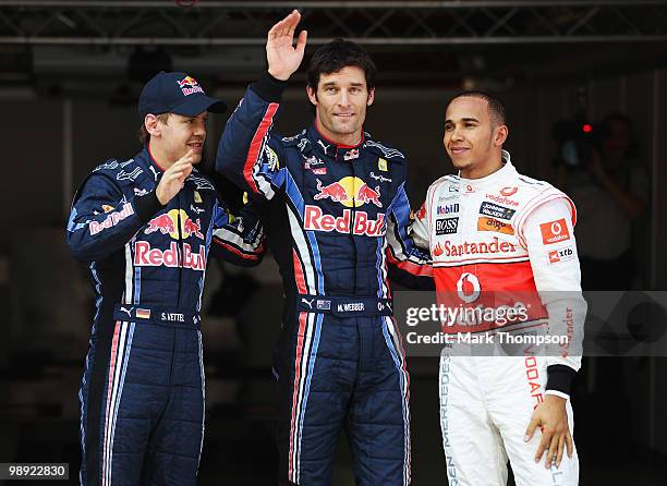 Second placed Sebastian Vettel of Germany and Red Bull Racing, first placed pole position sitter Mark Webber of Australia and Red Bull Racing and...