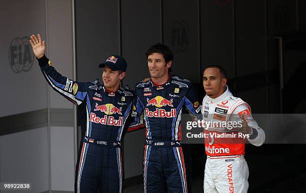 Second placed Sebastian Vettel of Germany and Red Bull Racing, first placed pole position sitter Mark Webber of Australia and Red Bull Racing and...