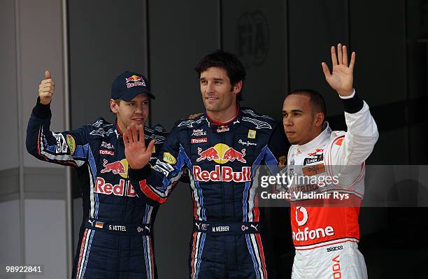 Second placed Sebastian Vettel of Germany and Red Bull Racing, first placed pole position sitter Mark Webber of Australia and Red Bull Racing and...