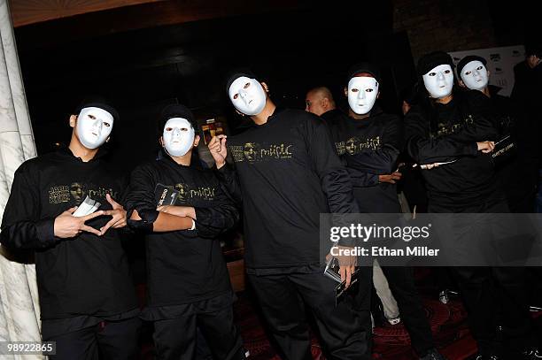 People wearing masks hand out JabbaWockeez material at the Tabu Ultra Lounge at the MGM Grand Hotel/Casino during the opening night of the...