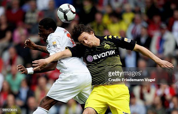 Neven Subotic of Dortmund and Mohamadou Idrissou of Freiburg jump for a header during the Bundesliga match between SC Freiburg and Borussia Dortmund...