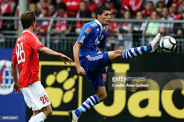 Kevin Kuranyi of Schalke controles the ball ahead of Niko Bungert of Mainz during the Bundesliga match between FSV Mainz 05 and FC Schalke 04 at the...