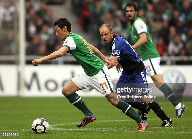 David Jarolim of Hamburg and Mesut Oezil of Bremen battle for the ball during the Bundesliga match between SV Werder Bremen and Hamburger SV at Weser...