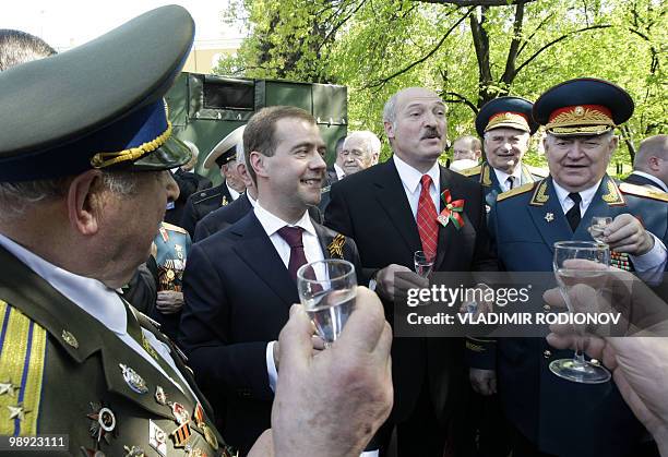 Russian President Dmitry Medvedev and Belarus President Alexander Lukashenko toast with WWII veterans near the Tomb of the Unknown Soldier in Moscow...