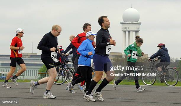 People take part in a fun run during the official opening of the "Tempelhofer Feld", at the former airport Tempelhof in Berlin on May 8, 2010. A part...