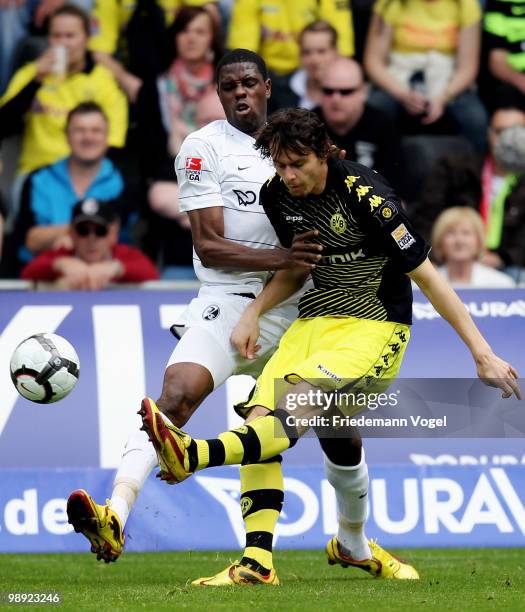 Neven Subotic of Dortmund and Mohamadou Idrissou of Freiburg battle for the ball during the Bundesliga match between SC Freiburg and Borussia...