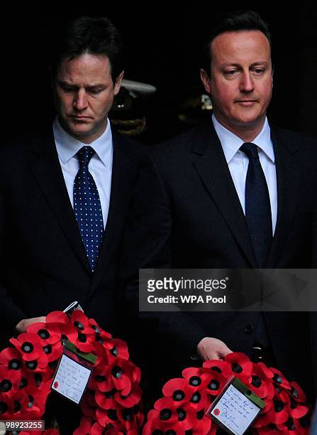 Conservative Party leader, David Cameron , and Liberal Democrat leader, Nick Clegg, stand during a Victory in Europe day ceremony on May 8, 2010 in...