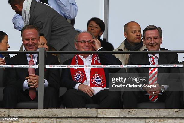 Karl Heinz Rummenigge, CEO of Bayern, President Uli Hoeness of Bayern and Karl Hopfner, CFO of FC Bayern Muenchen sit on the tribune during the...
