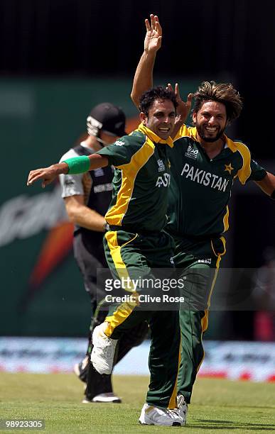 Abdur Rehman and Shahid Afridi celebrate the wicket of Martin Guptil of New Zealand during the ICC World Twenty20 Super Eight match between New...