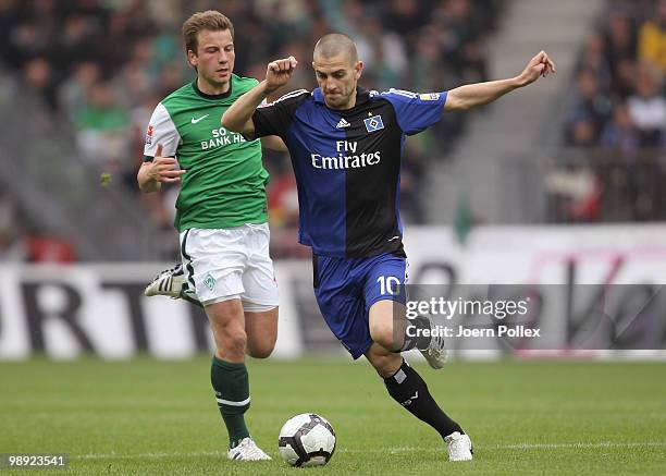 Mladen Petric of Hamburg and Philipp Bargfrede of Bremen battle for the ball during the Bundesliga match between SV Werder Bremen and Hamburger SV at...