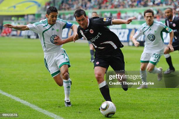 Josue of Wolfsburg and Martin Fenin of Frankfurt fight for the ball during the Bundesliga match between VfL Wolfsburg and Eintracht Frankfurt at...