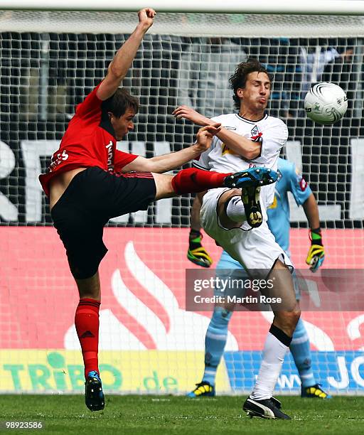 Roel Brouwers of Gladbach and Patrick Helmes of Leverkusen battle for the ball during the Bundesliga match between Borussia Moenchengladbach and...