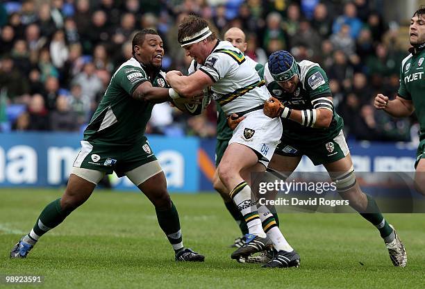 Dylan Hartley of Northampton is tackled by Steffon Armitage and Kieran Roche during the Guinness Premiership match between London Irish and...