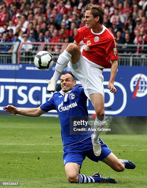 Niko Bungert of Mainz is challenged by Heiko Westermann of Schalke during the Bundesliga match between FSV Mainz 05 and FC Schalke 04 at the Bruchweg...