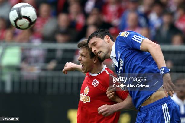 Kevin Kuranyi of Schalke jumps for a header with Radoslav Zabavnik of Mainz during the Bundesliga match between FSV Mainz 05 and FC Schalke 04 at the...